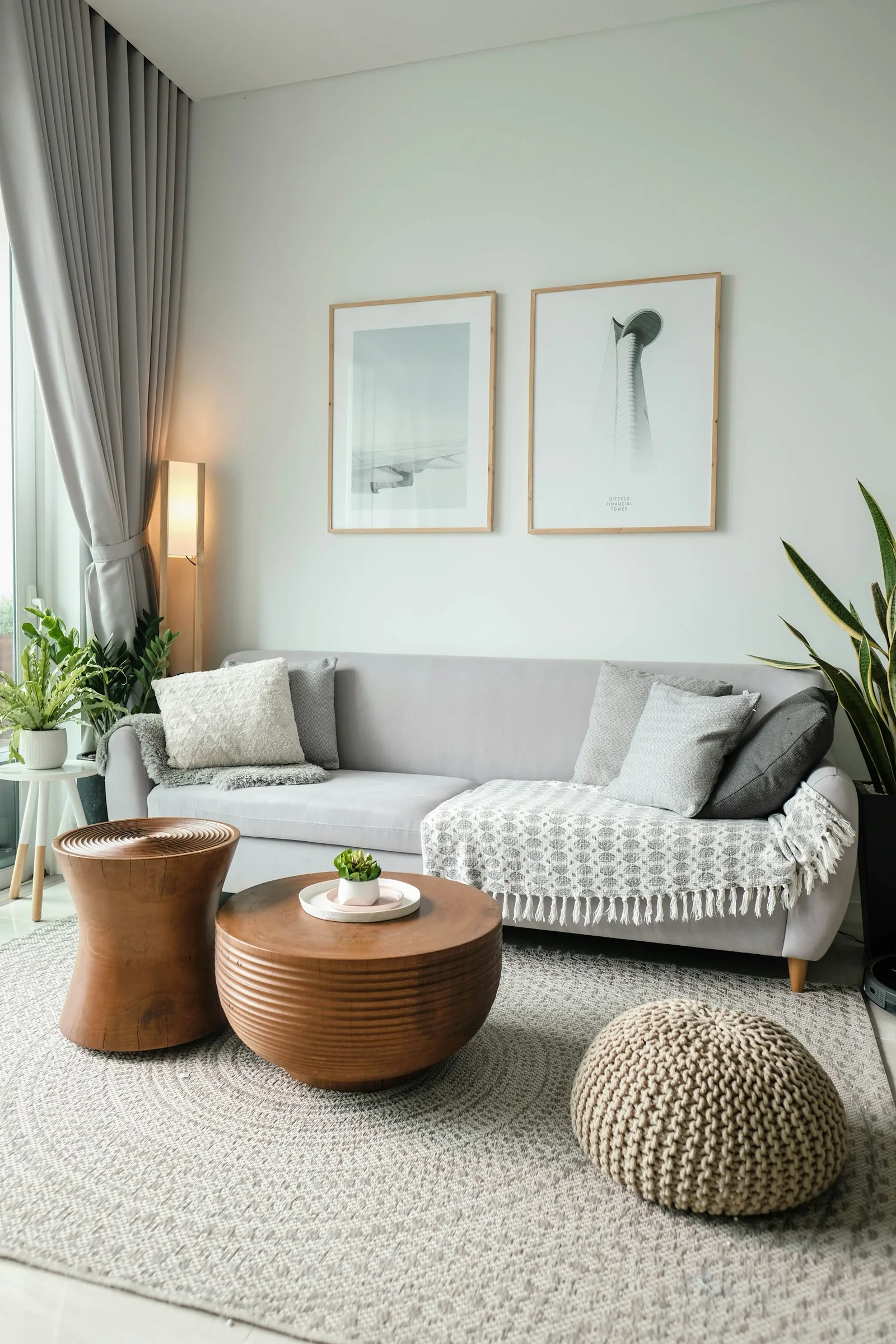 A living room with a sofa, artwork and natural light.